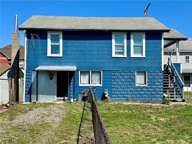 87R 26th St, Wellsburg, WV 26070 - rear view of house featuring fence, stairway, and a yard