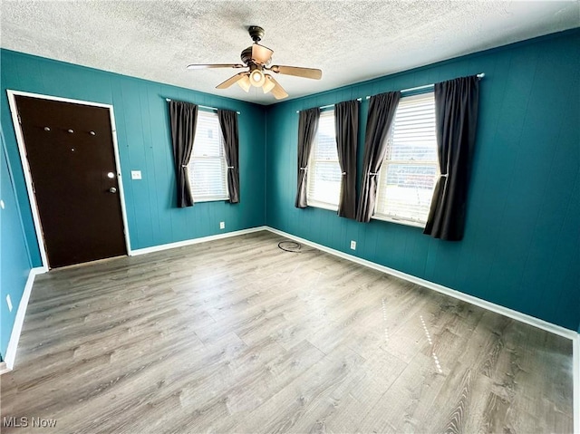 87R 26th St, Wellsburg, WV 26070 - spare room featuring a textured ceiling, ceiling fan, and wood finished floors
