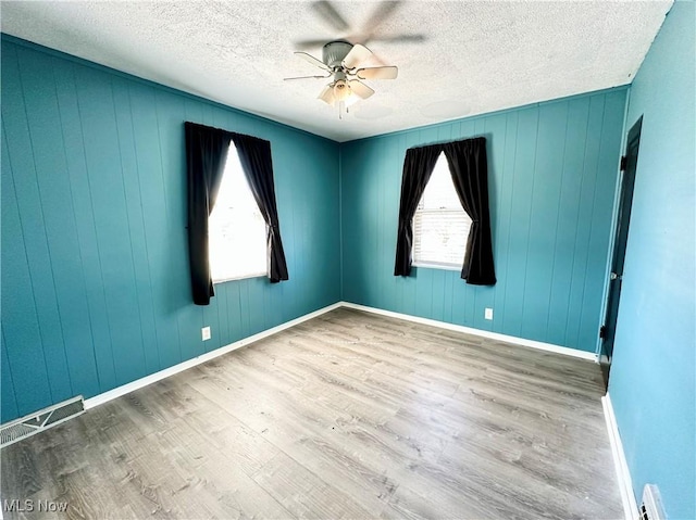87R 26th St, Wellsburg, WV 26070 - empty room with baseboards, a textured ceiling, ceiling fan, visible vents, and wood finished floors