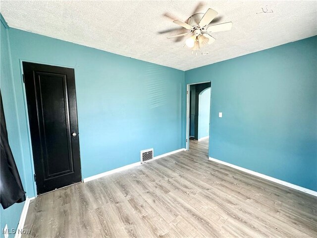 87R 26th St, Wellsburg, WV 26070 - unfurnished room featuring a textured ceiling, visible vents, baseboards, ceiling fan, and wood finished floors