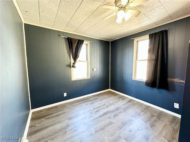 87R 26th St, Wellsburg, WV 26070 - spare room with wood finished floors, a ceiling fan, and plenty of natural light