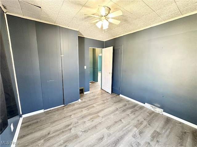87R 26th St, Wellsburg, WV 26070 - unfurnished bedroom with baseboards, visible vents, ceiling fan, and wood finished floors