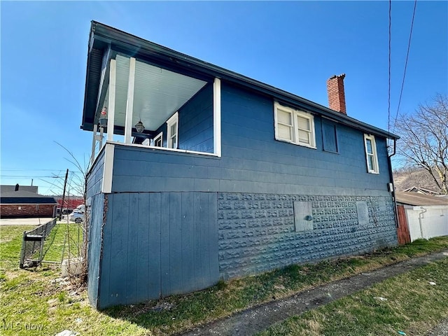 87R 26th St, Wellsburg, WV 26070 - view of property exterior with a chimney
