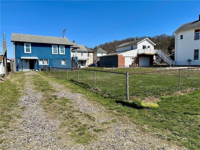 87R 26th St, Wellsburg, WV 26070 - view of yard with driveway, a garage, a fenced backyard, and stairway