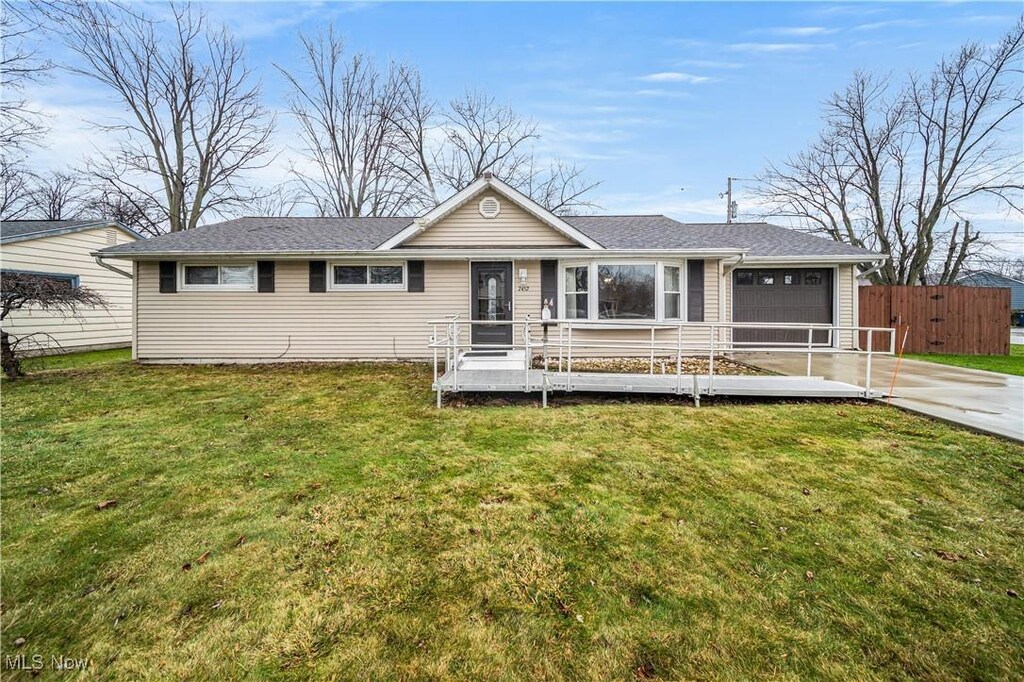 7452 Goldenrod Dr, Mentor-On-The-Lake, OH 44060 - ranch-style house with a front lawn, fence, driveway, and an attached garage