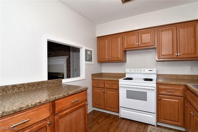 kitchen featuring dark wood-style floors, a fireplace, brown cabinetry, and white electric range oven