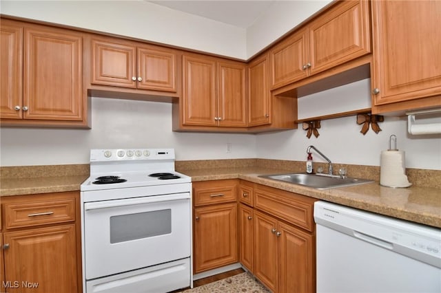 kitchen with light countertops, a sink, brown cabinetry, and white appliances