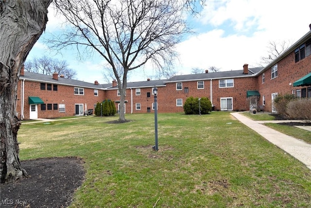 view of home's community featuring a lawn