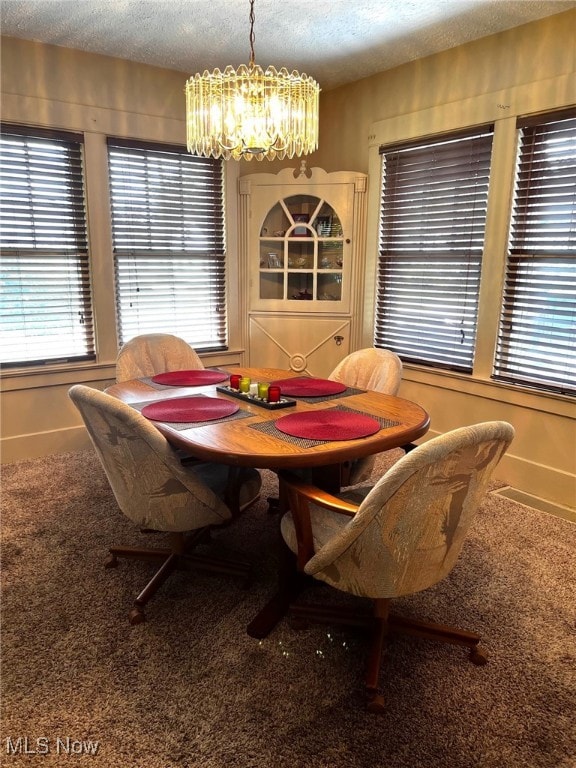 1275 Hollywood, Warren, OH 44483 - dining area featuring a chandelier, carpet floors, a textured ceiling, plenty of natural light, and baseboards