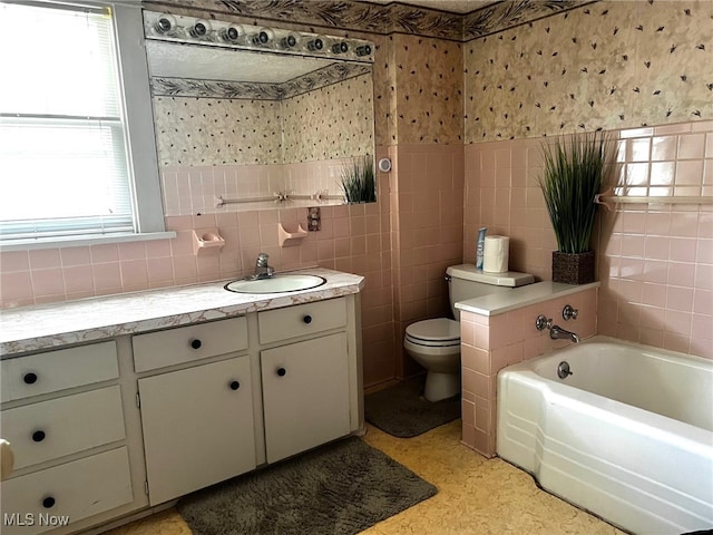 1275 Hollywood, Warren, OH 44483 - bathroom with tile walls, wallpapered walls, toilet, a garden tub, and wainscoting
