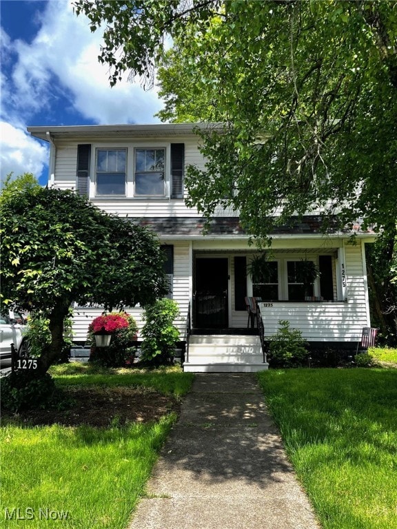1275 Hollywood, Warren, OH 44483 - view of property hidden behind natural elements featuring a front lawn and covered porch