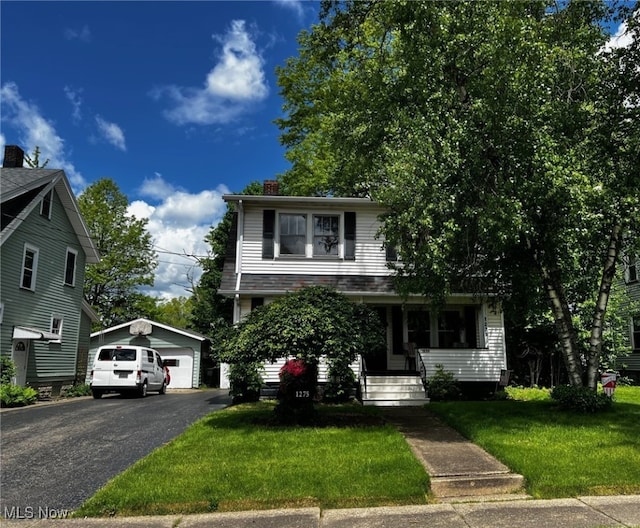 1275 Hollywood, Warren, OH 44483 - view of front of property with an outbuilding, a chimney, a garage, a front yard, and covered porch