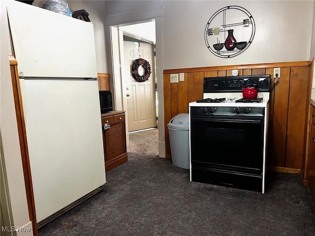 1275 Hollywood, Warren, OH 44483 - kitchen with freestanding refrigerator, gas range, dark carpet, black microwave, and brown cabinetry