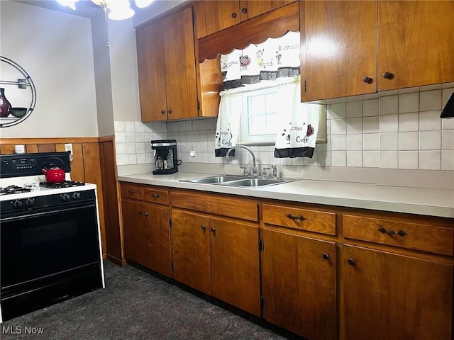 1275 Hollywood, Warren, OH 44483 - kitchen with gas range, a sink, light countertops, and brown cabinetry
