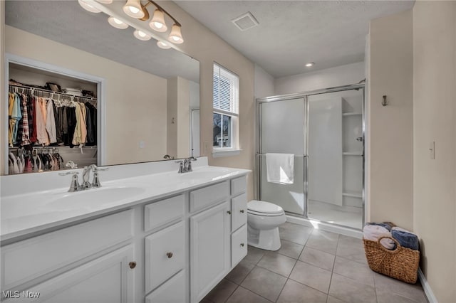 full bathroom featuring a sink, visible vents, tile patterned floors, and double vanity
