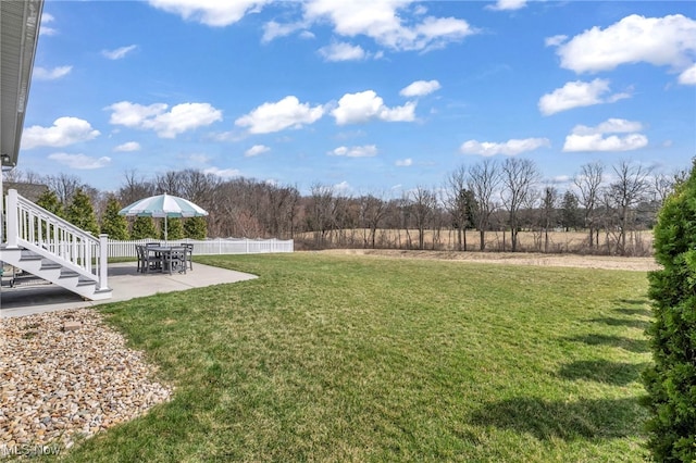 view of yard featuring a patio area and fence