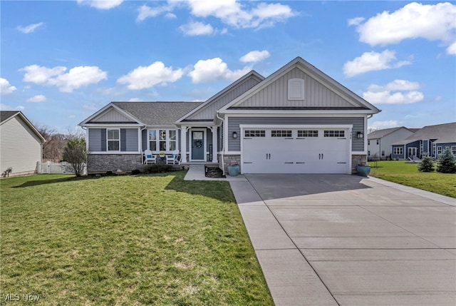 craftsman-style home featuring board and batten siding, an attached garage, stone siding, and driveway