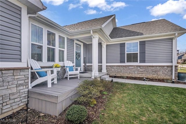 deck featuring a porch and a lawn