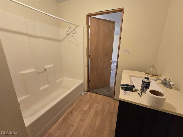 bathroom with vanity, shower / bathtub combination, and wood finished floors