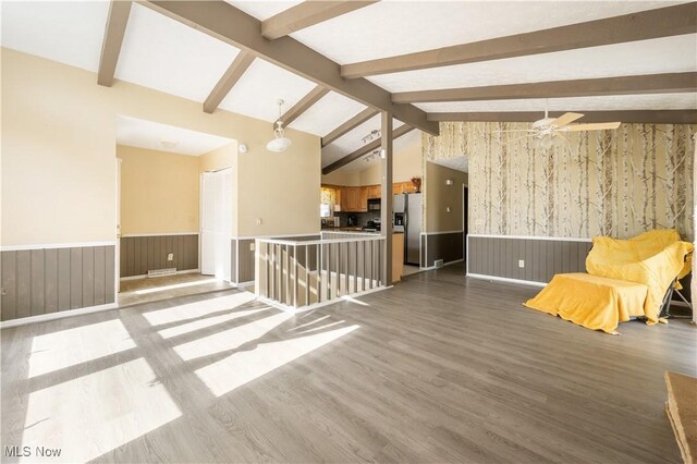 70 Iroquois Trl, Malvern, OH 44644 - empty room featuring a wainscoted wall, vaulted ceiling with beams, and wood finished floors