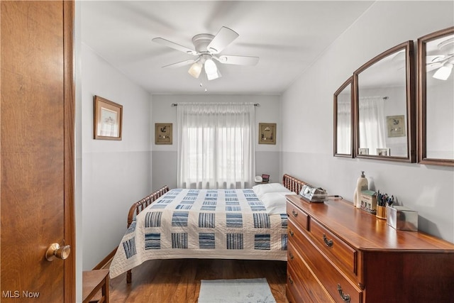 bedroom featuring ceiling fan and dark wood-type flooring
