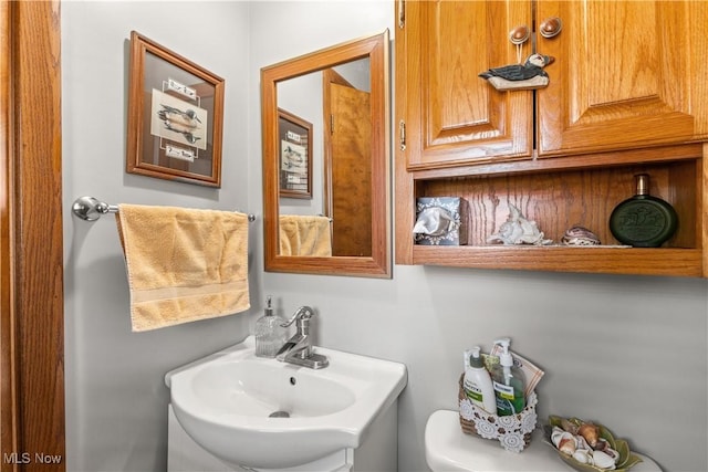 half bath with toilet and a sink