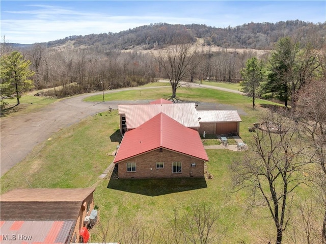 drone / aerial view with a wooded view