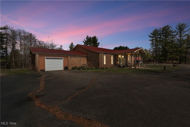 view of front facade featuring driveway and an attached garage