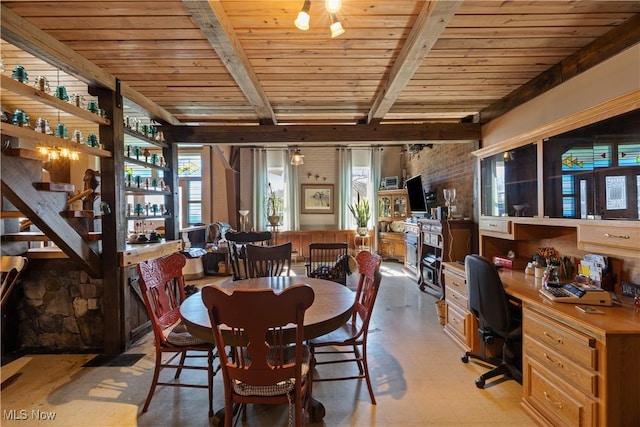 dining room with built in study area, light floors, wood ceiling, and beam ceiling