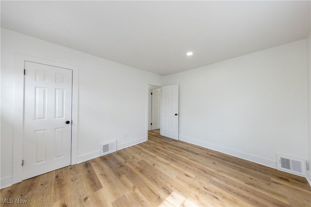 unfurnished room with baseboards, visible vents, recessed lighting, and light wood-type flooring
