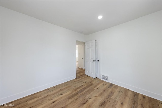 spare room with baseboards, visible vents, recessed lighting, and light wood-type flooring