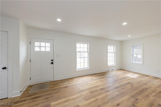 foyer featuring baseboards, visible vents, light wood-style flooring, and recessed lighting