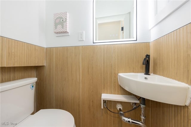 half bathroom with toilet and a sink