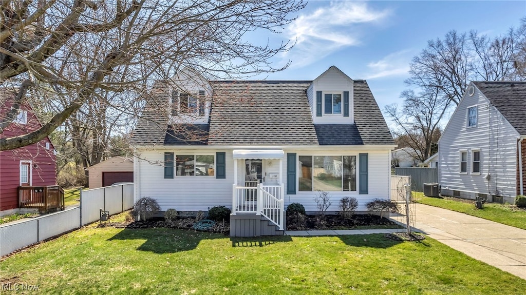view of front of home with fence, central AC, concrete driveway, a front lawn, and a shingled roof