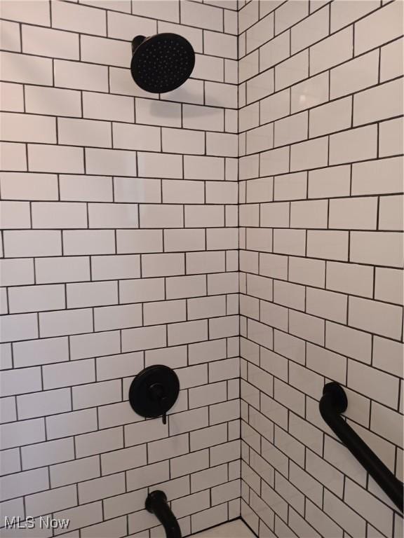 bathroom with a tile shower