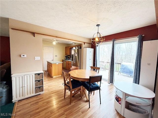 380 Sunshine Park Rd, Steubenville, OH 43952 - dining space with a textured ceiling, a ceiling fan, and light wood-type flooring