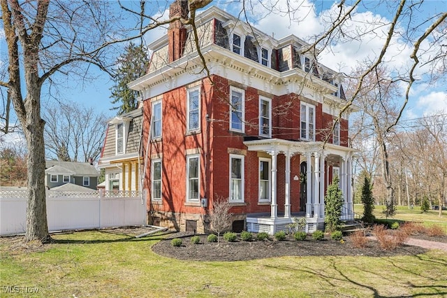 500 S Main St, Poland, OH 44514 - view of front of home featuring a front yard, covered porch, a chimney, mansard roof, and fence