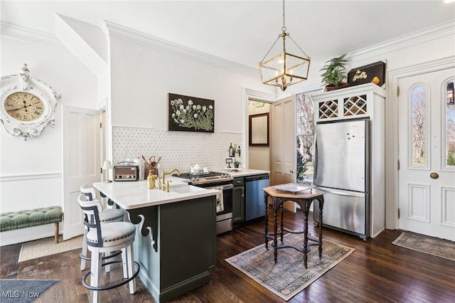 500 S Main St, Poland, OH 44514 - kitchen with light countertops, backsplash, appliances with stainless steel finishes, ornamental molding, and dark wood-style flooring