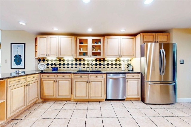 kitchen featuring tasteful backsplash, appliances with stainless steel finishes, a sink, open shelves, and light tile patterned floors