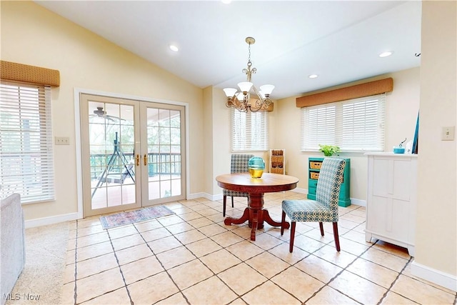 dining area featuring a wealth of natural light, vaulted ceiling, french doors, and an inviting chandelier