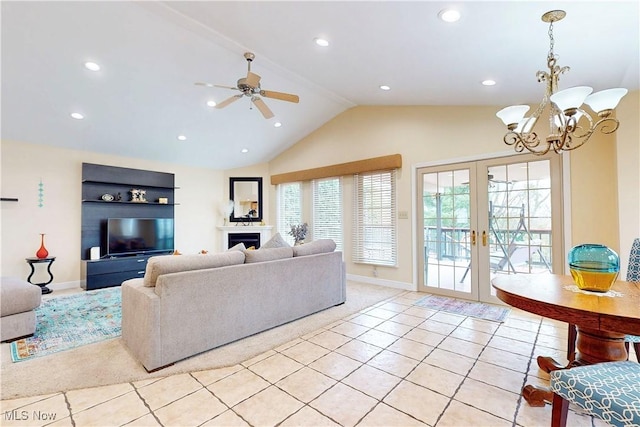 living area with vaulted ceiling, recessed lighting, french doors, light tile patterned floors, and ceiling fan with notable chandelier