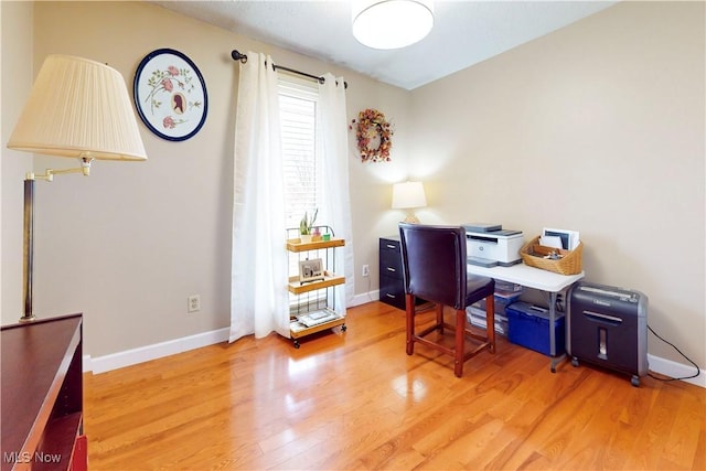 office space featuring baseboards and wood finished floors