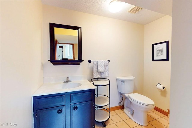 bathroom with visible vents, baseboards, toilet, tile patterned floors, and vanity