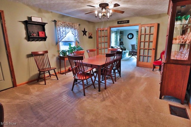 26949 County Road 25, Warsaw, OH 43844 - carpeted dining room featuring french doors, baseboards, a textured ceiling, visible vents, and a ceiling fan
