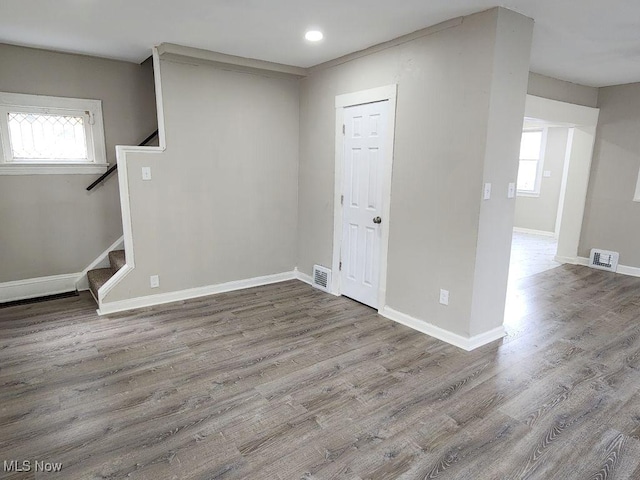 below grade area featuring visible vents, wood finished floors, and a healthy amount of sunlight
