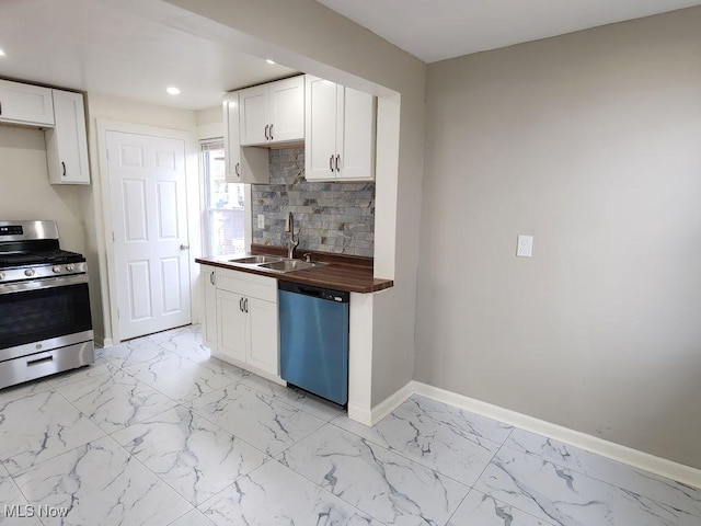 kitchen featuring dishwashing machine, gas stove, a sink, wood counters, and decorative backsplash