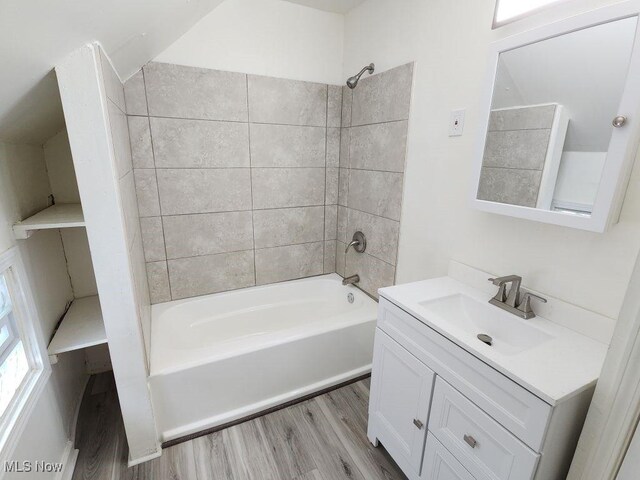 full bath featuring vanity, shower / tub combination, and wood finished floors