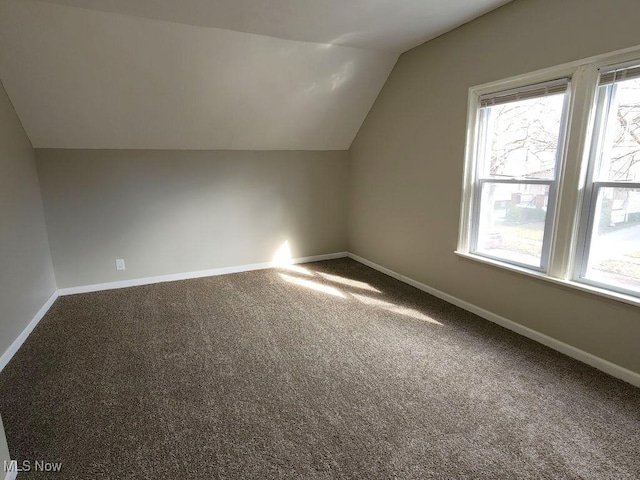 bonus room with a wealth of natural light, carpet flooring, and vaulted ceiling