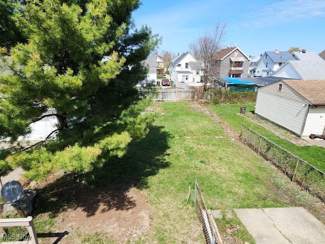 view of yard with a residential view and fence