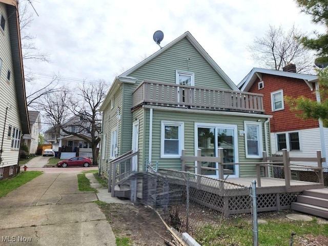 rear view of property featuring a balcony